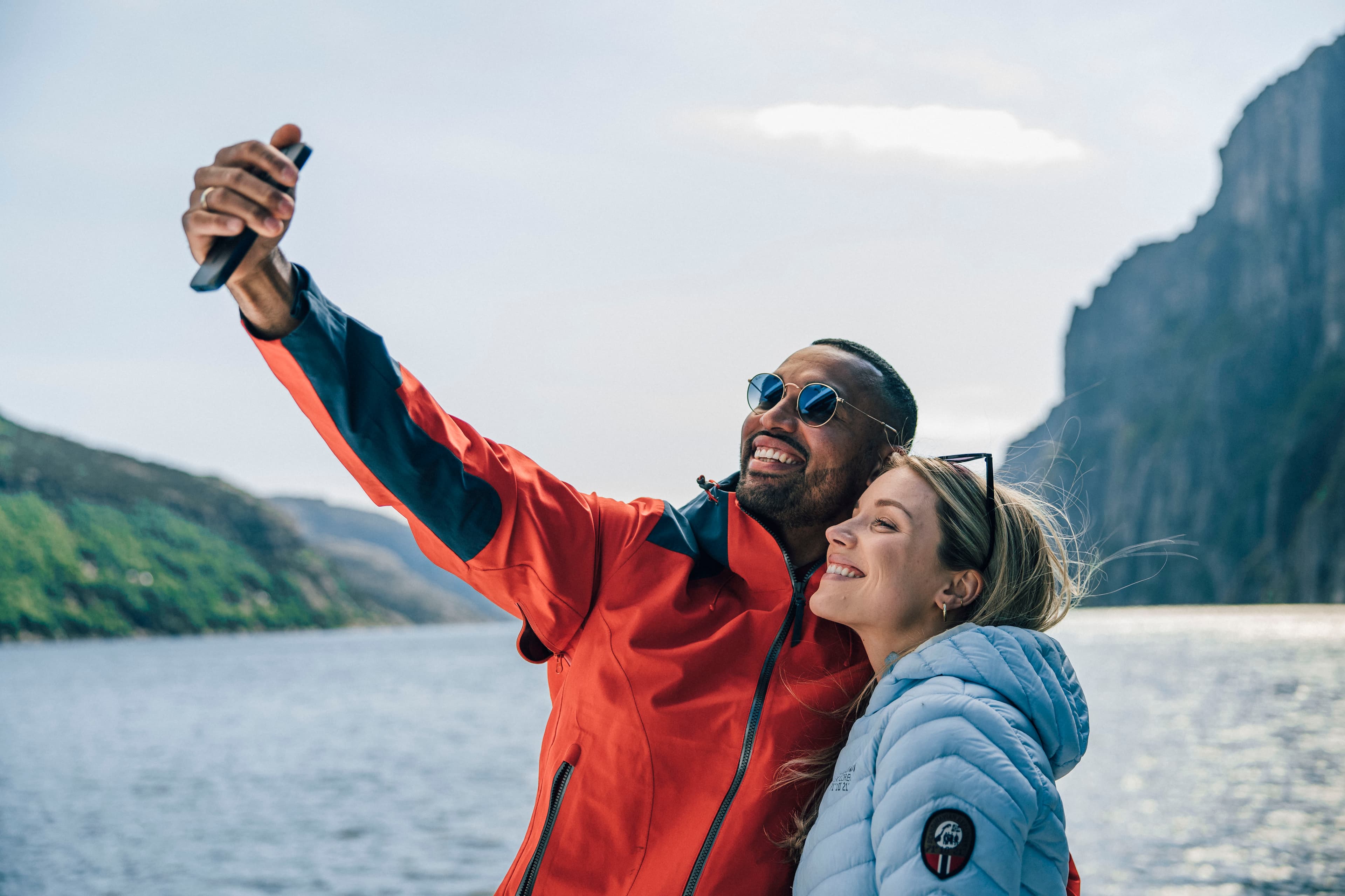 Couple on fjord cruise taking selfie