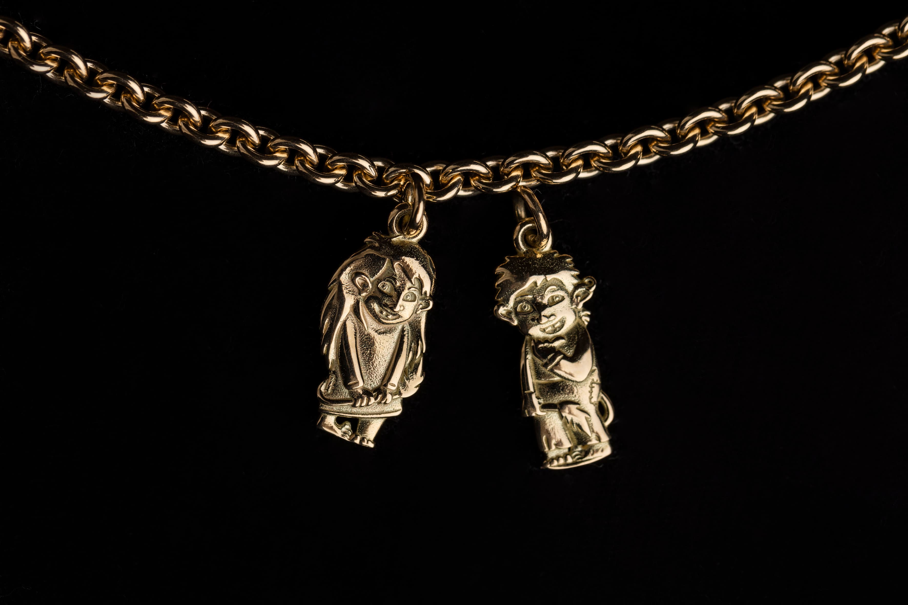 Two troll jewlery, girl and boy on a chain