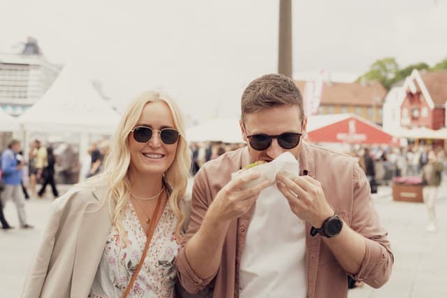 People on the food festival Gladmat in Stavanger either serving food or guests eating food