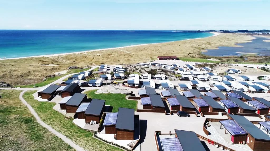 Beach and campsite near the beach, photo taken from above. Long beachline and the north sea.