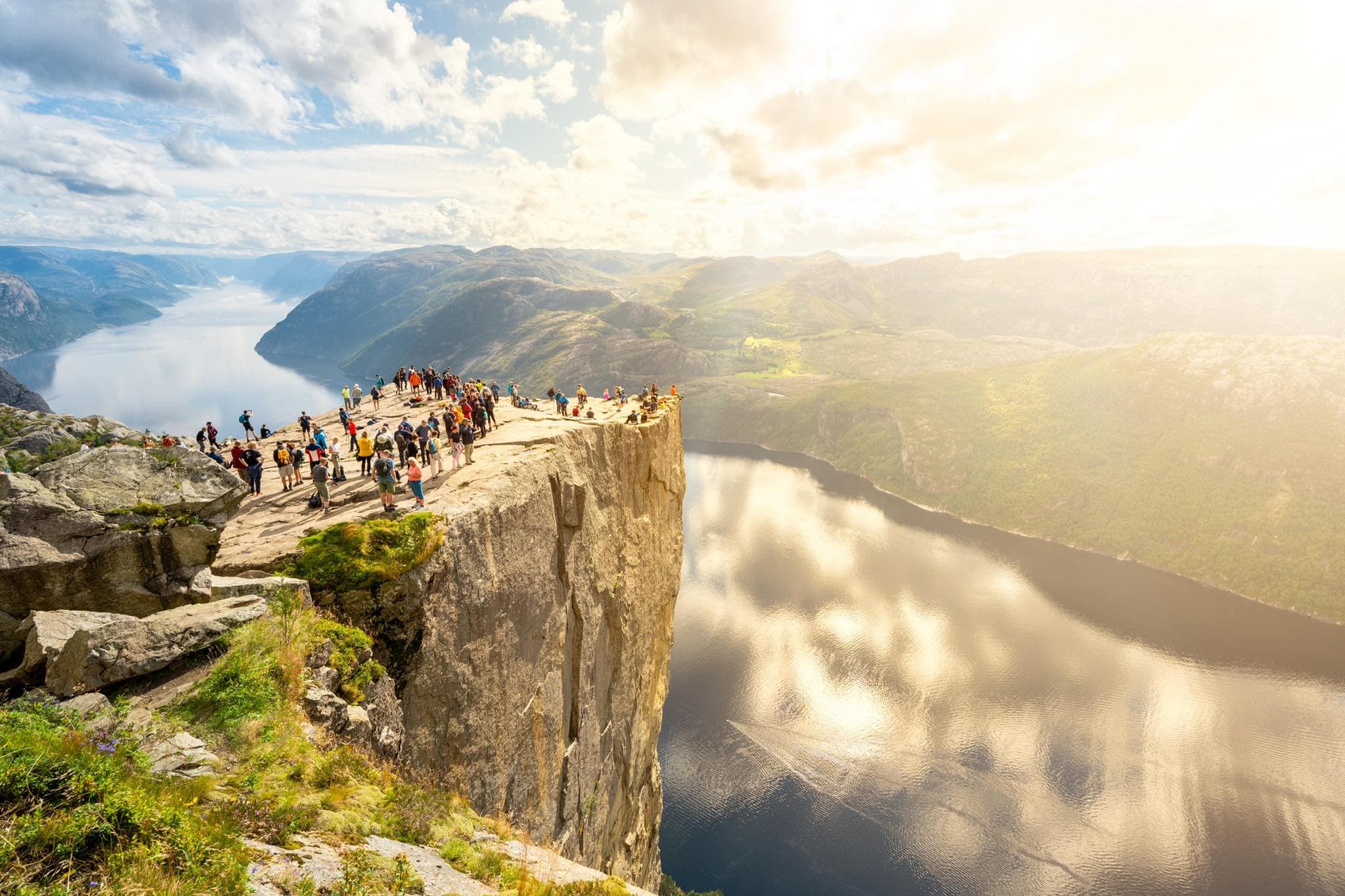preikestolen in Norway with people on top and the Lysefjord
