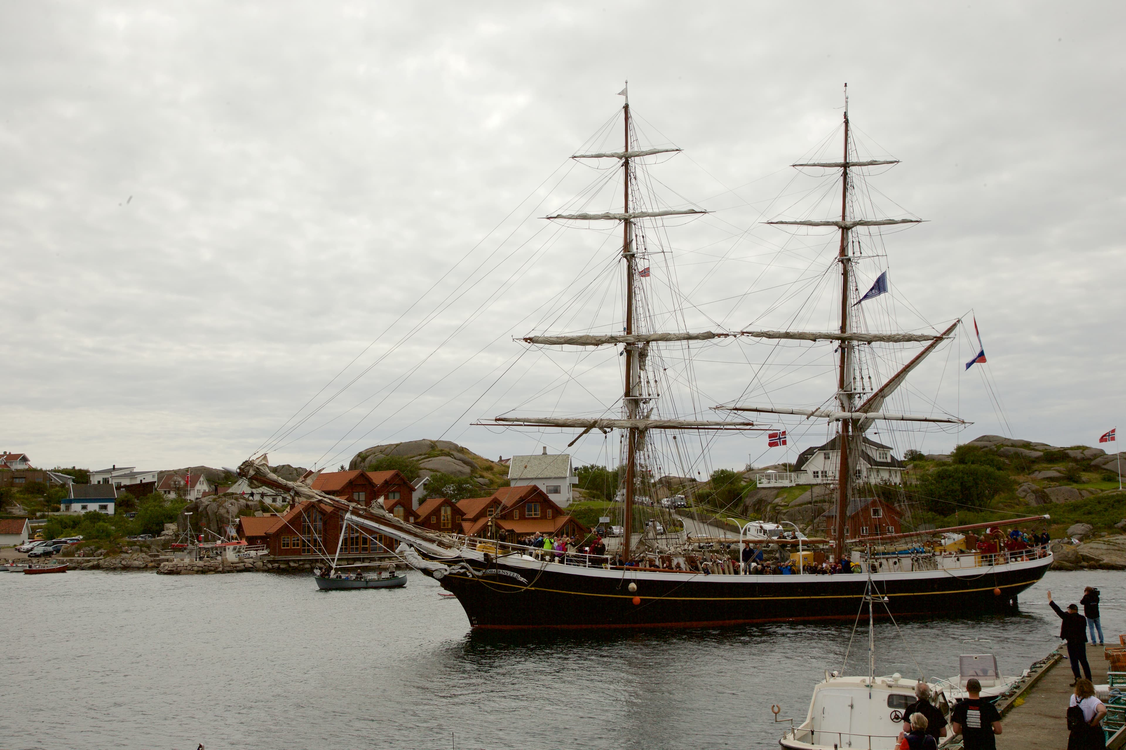 A wooden sailing ship in the harbour during a tall ships race