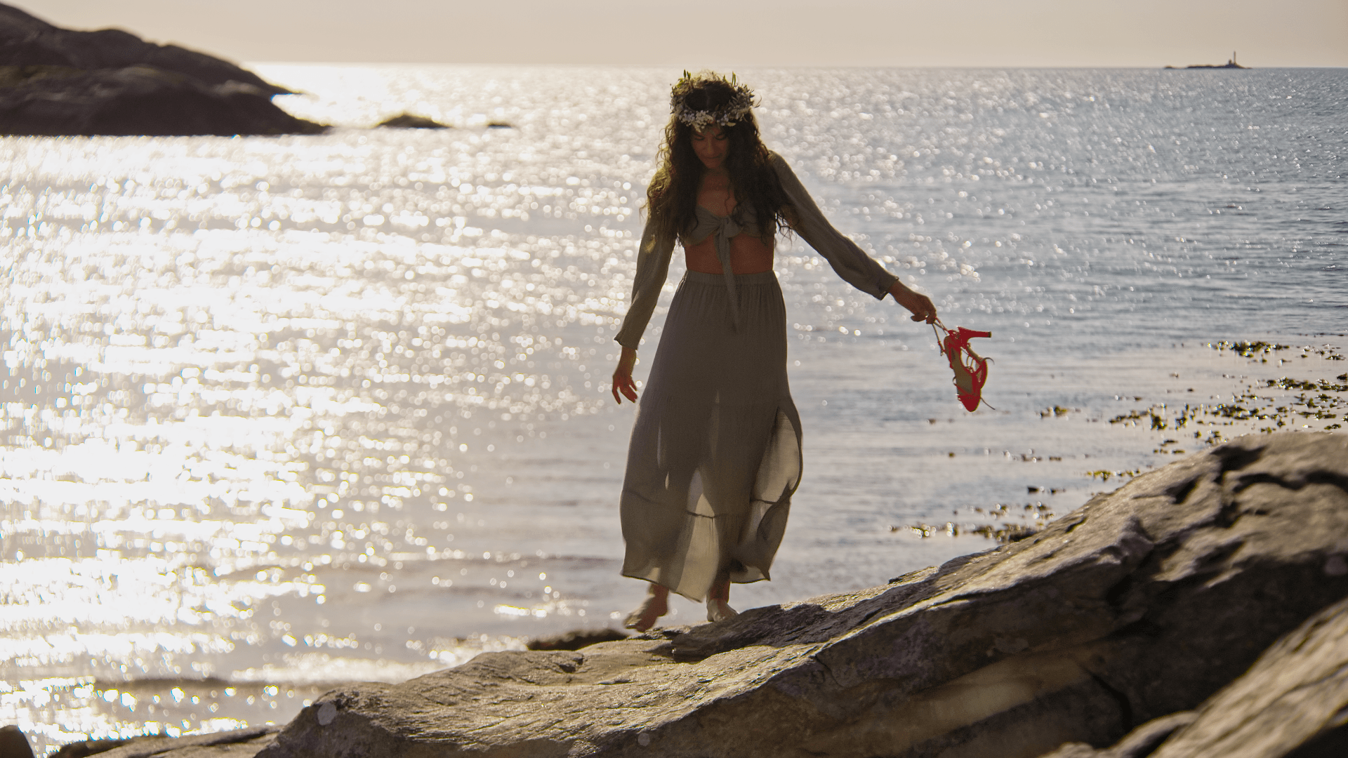 lady walking along the sea barefoot