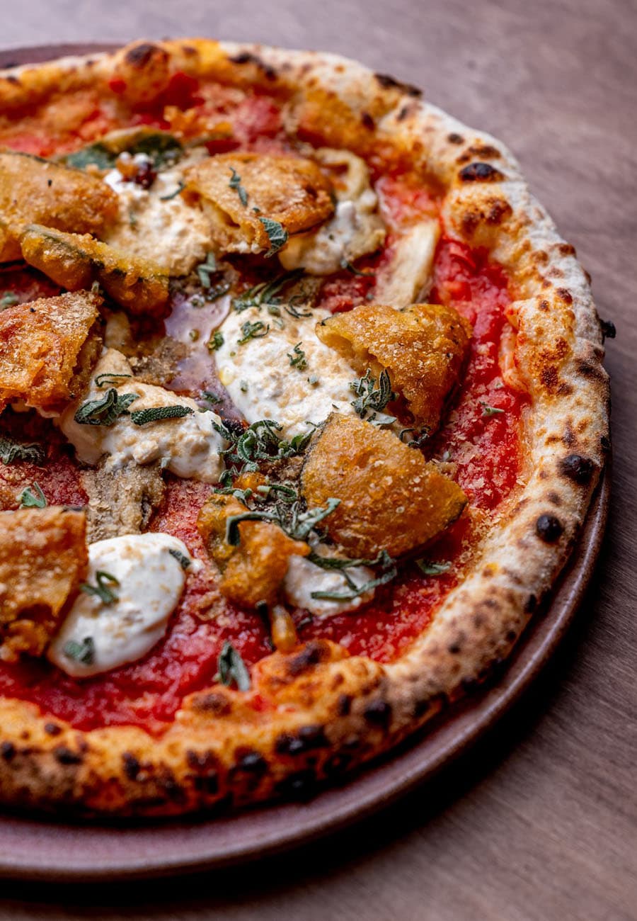 Food and people eating at restaurant Bellies - vegan restaurant