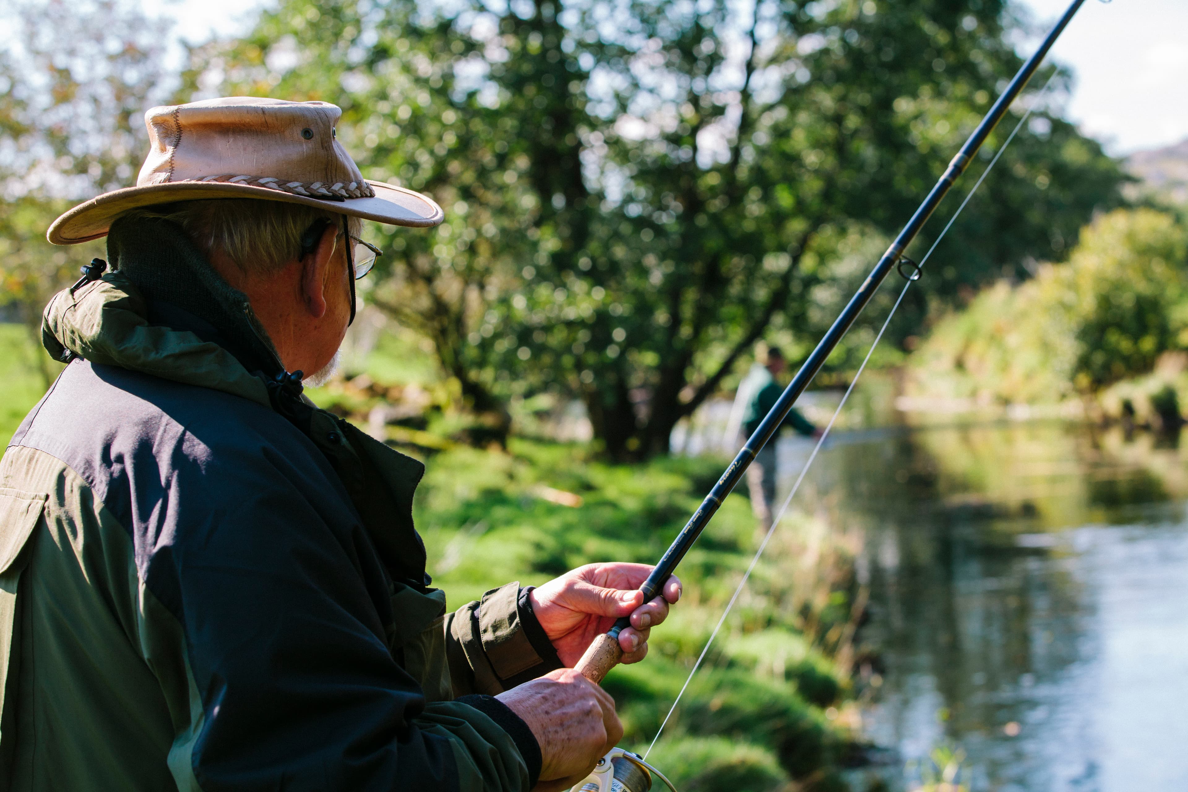 Man fishing with rod in river