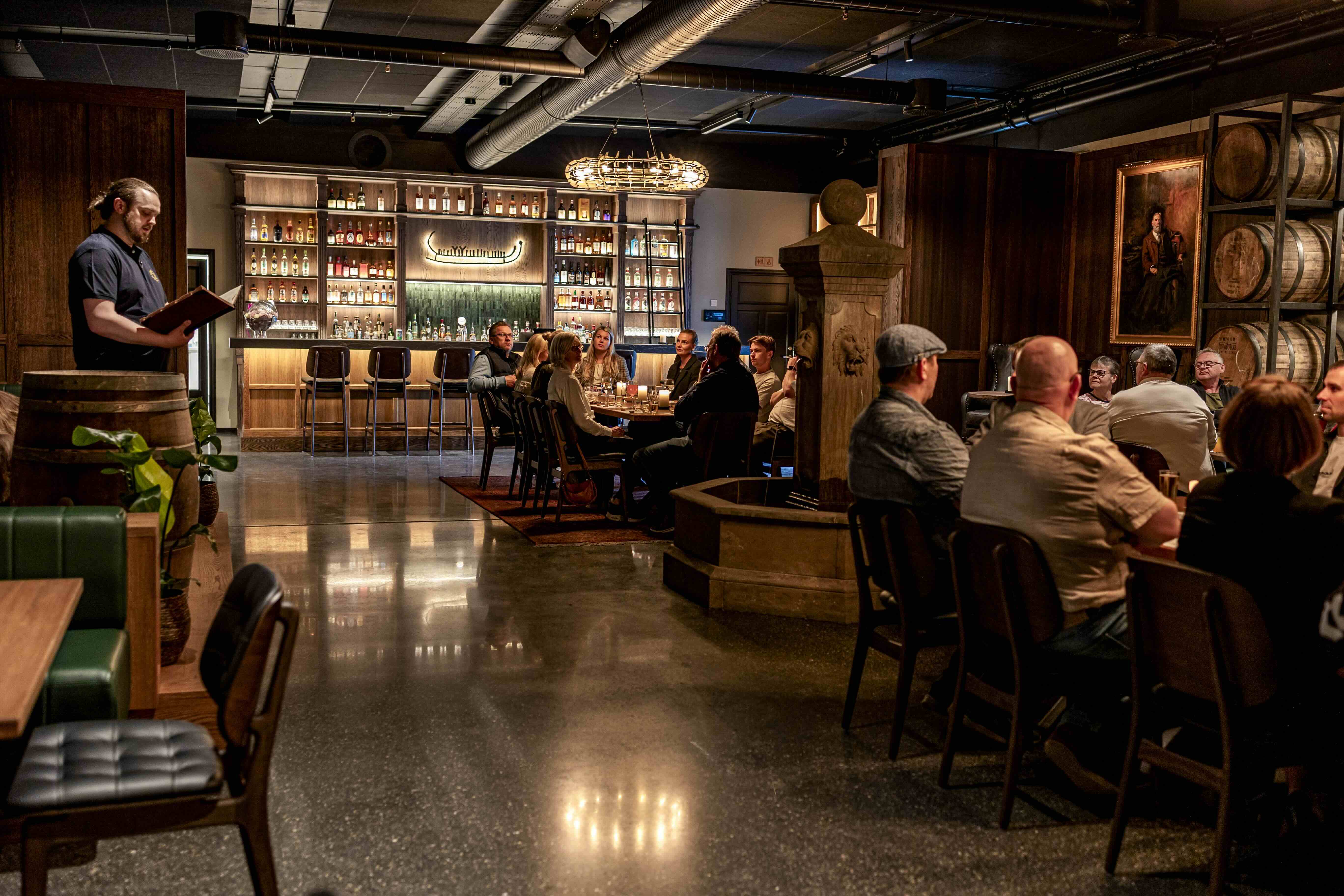 Whisky tour - people in bar at the distillery listening to whisky tour guide at Berentsens Brygghus & Distillery