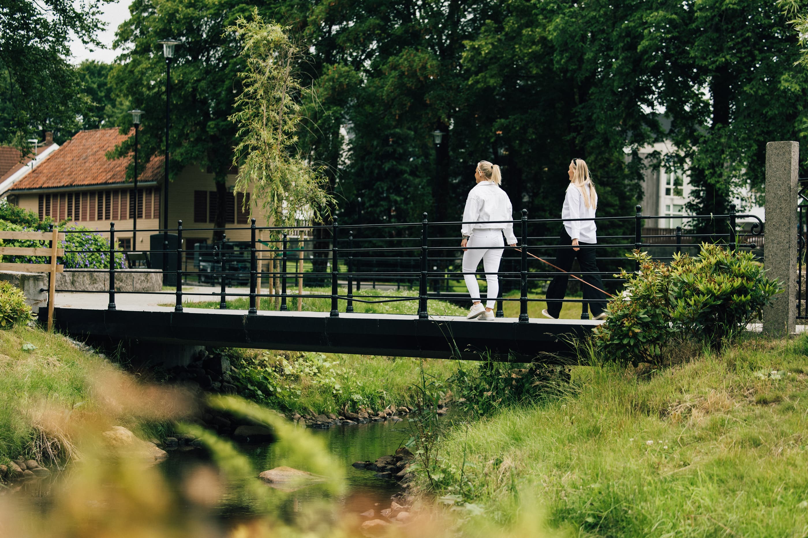 Two women and dog walking along Stangelandsåna in Sandnes