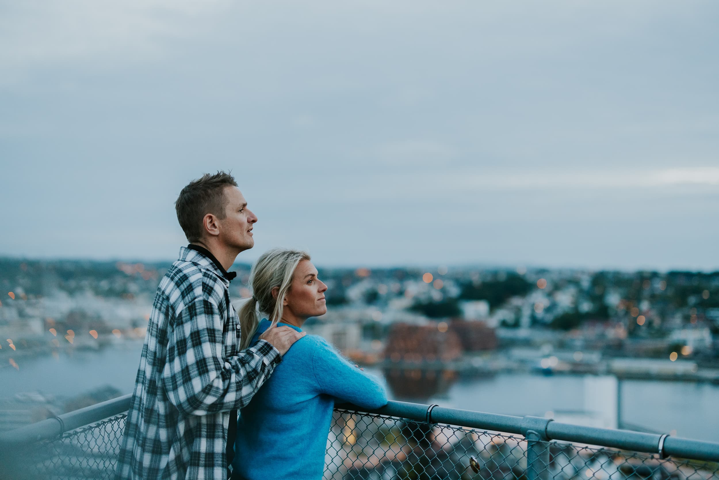 Two people and a dog walking up the stairs to the mountain Hanafjellet. The stairs are called Hanatrappene. From the top the view shows Sandnes and fjord