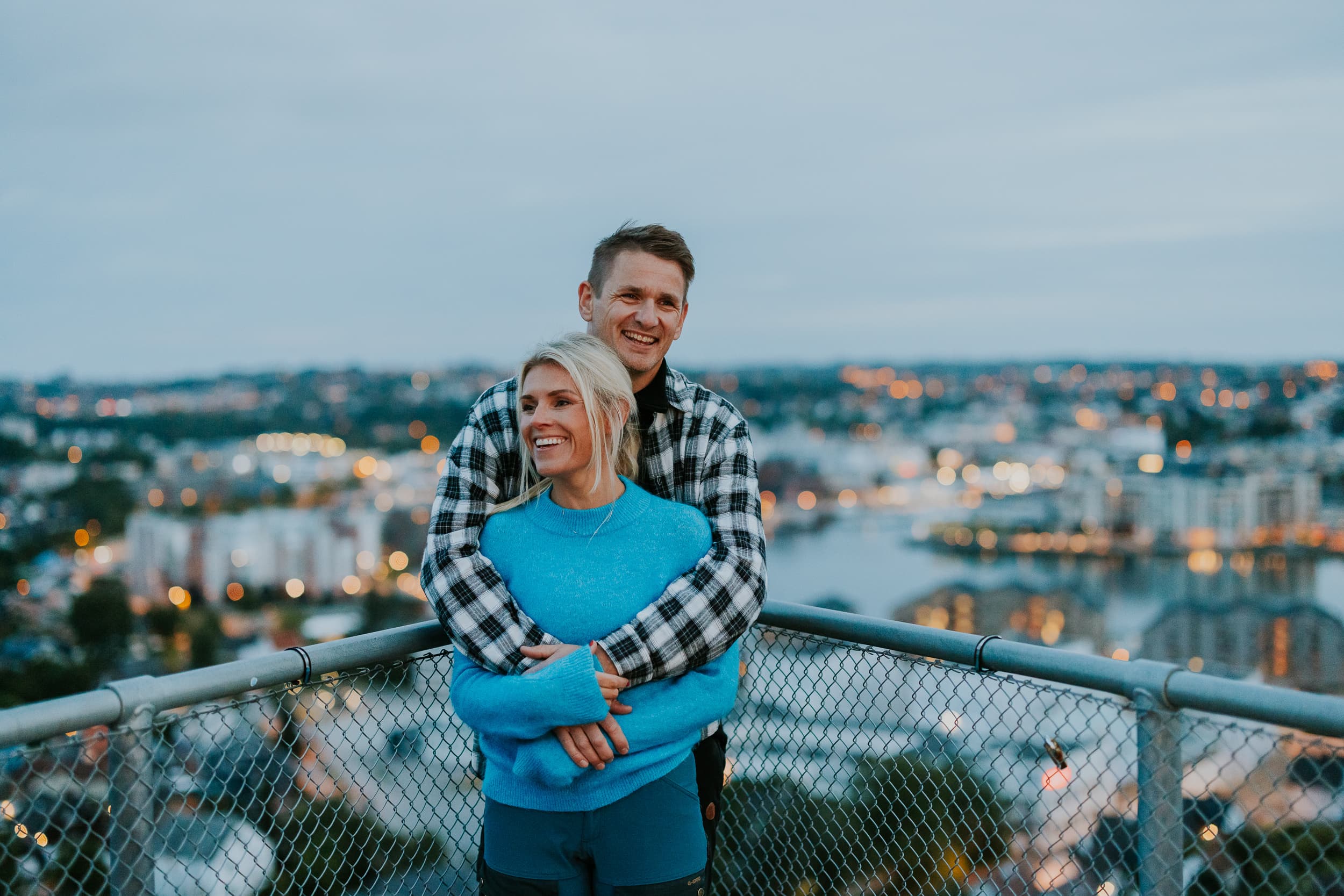 Two people and a dog walking up the stairs to the mountain Hanafjellet. The stairs are called Hanatrappene. From the top the view shows Sandnes and fjord