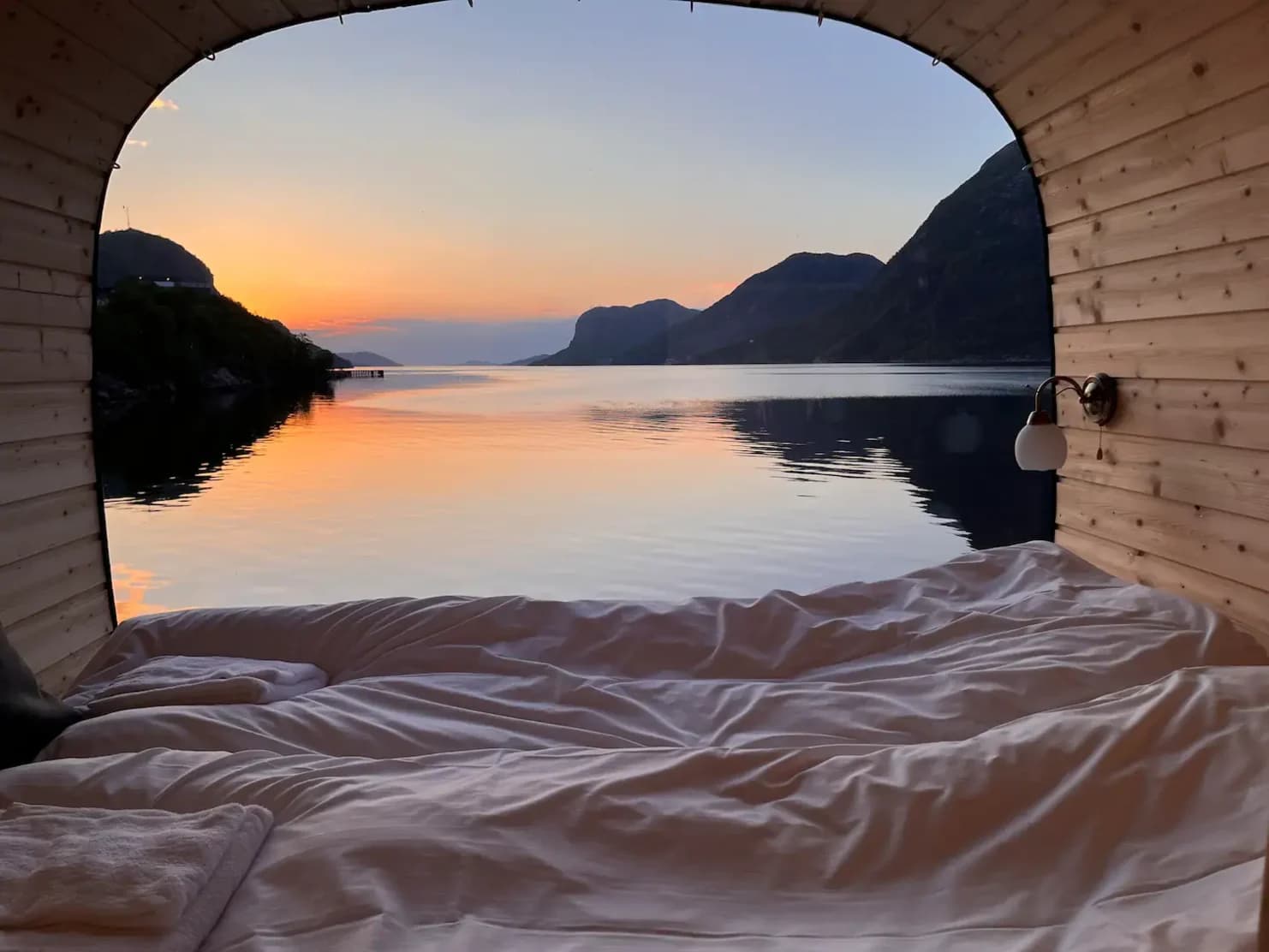 views and interior of tiny house accommodation with views of fjord