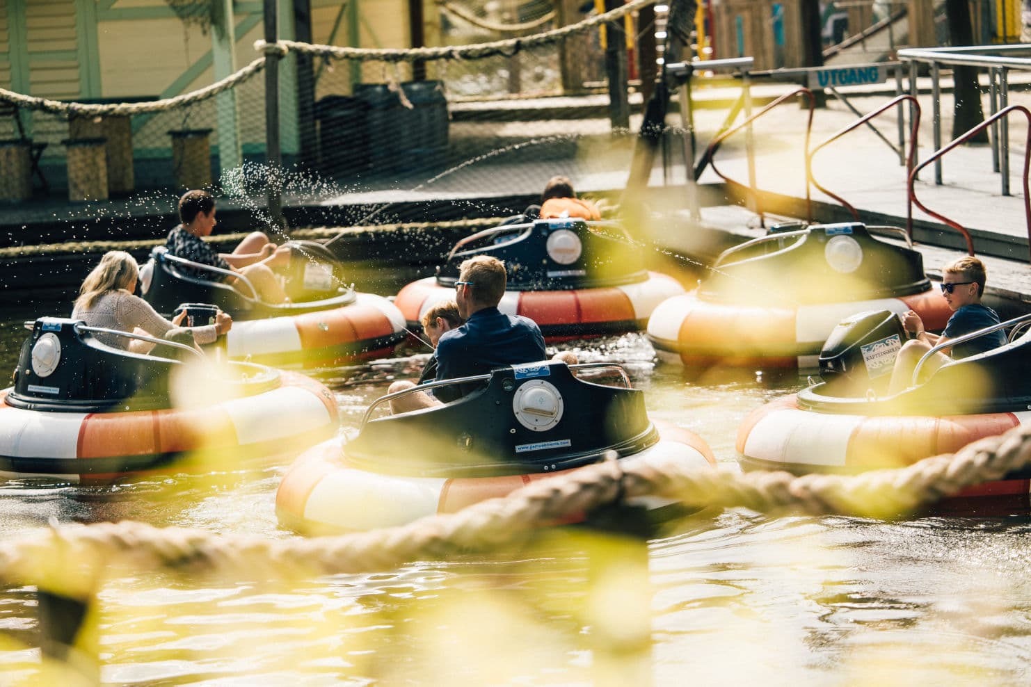 family enjoying themselves in different rides at an amusement park