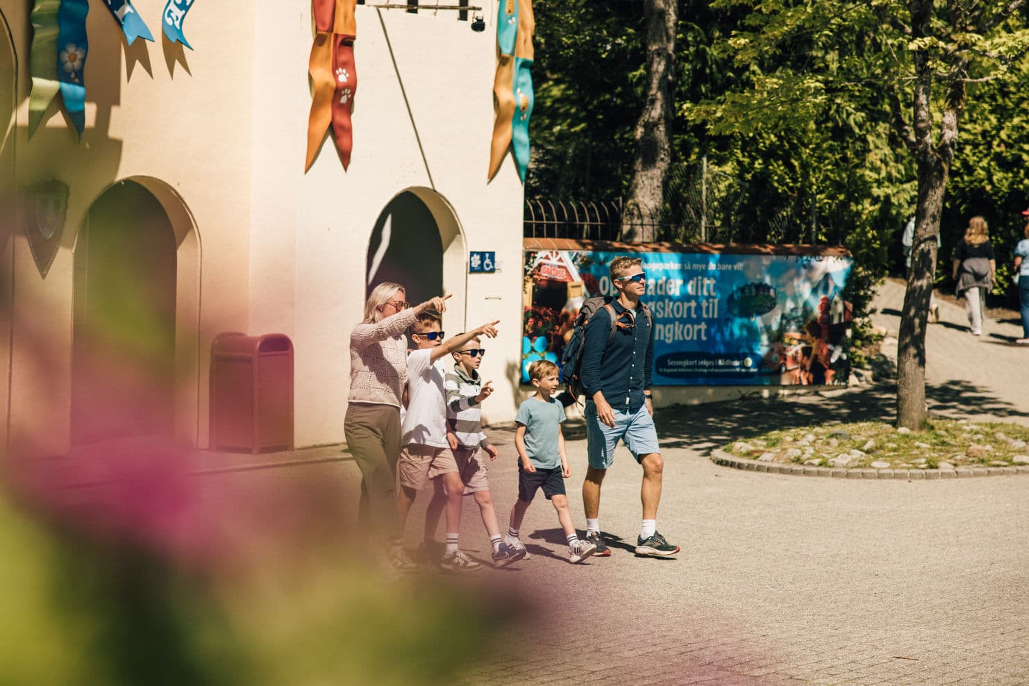 family enjoying themselves in different rides at an amusement park