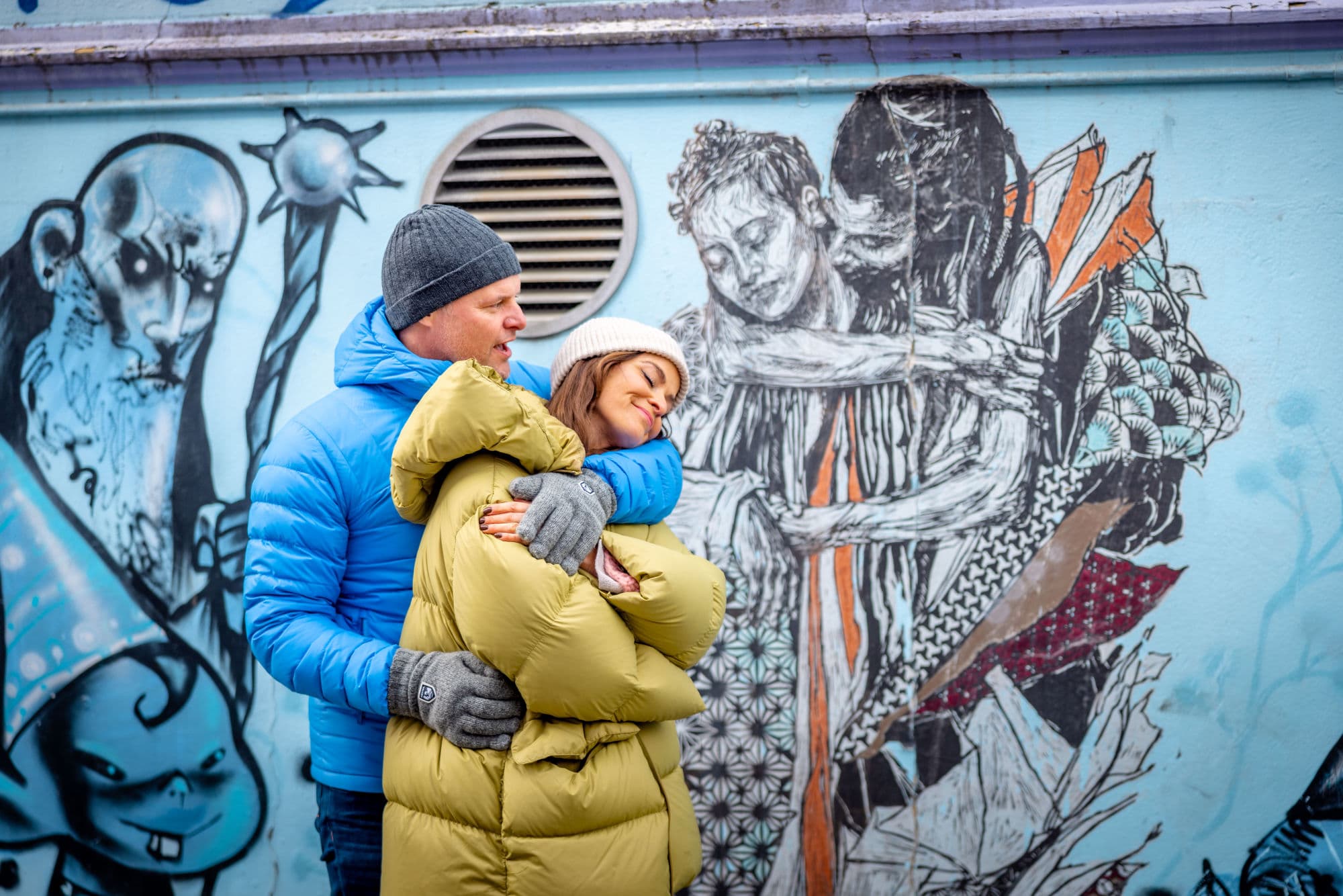 Fargegaten Stavanger - a man and woman strolling and visiting shops and cafes in the street of colours in stavanger. They look at street art and houses.