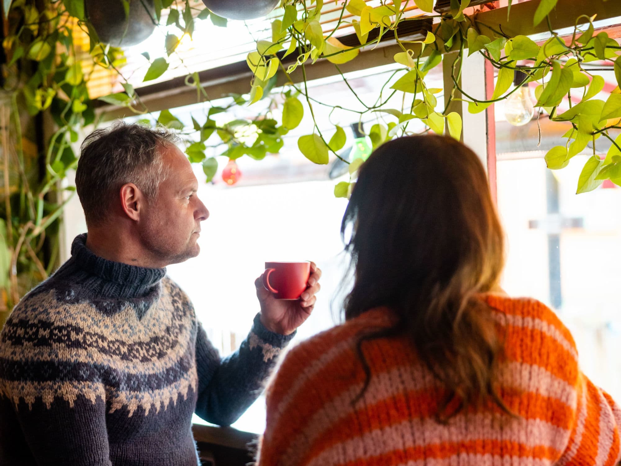 Fargegaten Stavanger - a man and woman strolling and visiting shops and cafes in the street of colours in stavanger. They look at street art and houses.