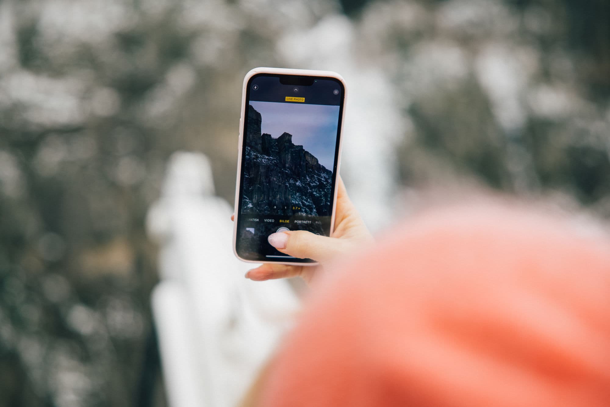 Family on fjord cruise in the Norwegian fjords during winter, beautiful fjord scenery, family taking pictures from sightseeing boat, mountainsides with snowcapped tops