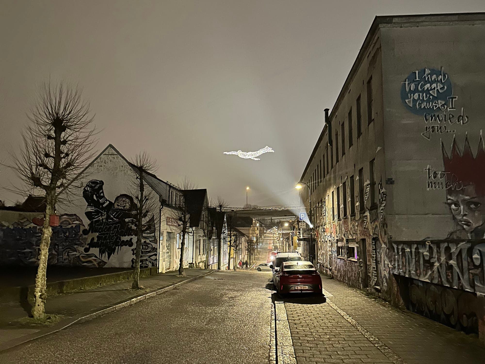 light sculptures shaped like a man hanging above popular street in Stavanger