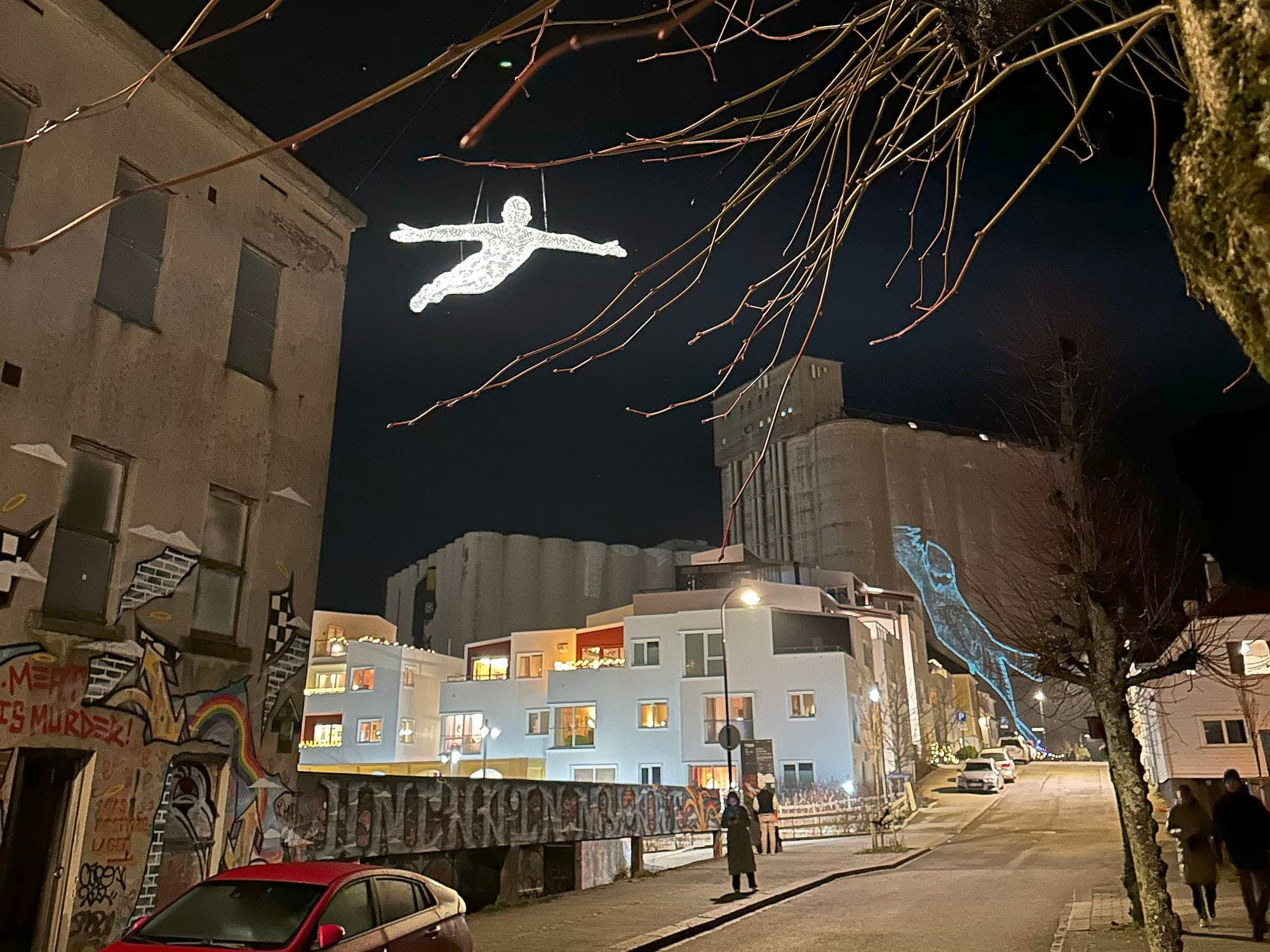 light sculptures shaped like a man hanging above popular street in Stavanger