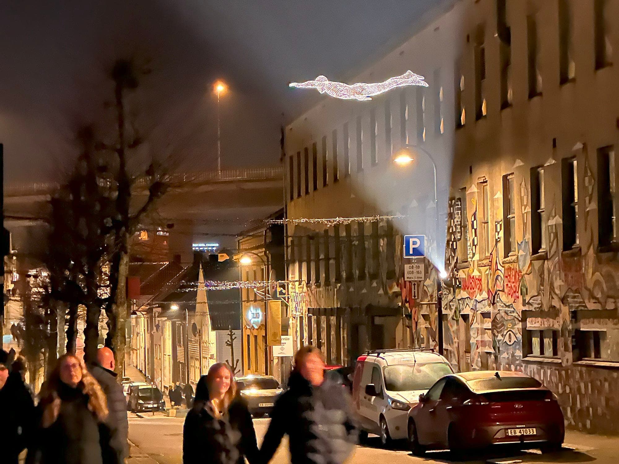 light sculptures shaped like a man hanging above popular street in Stavanger