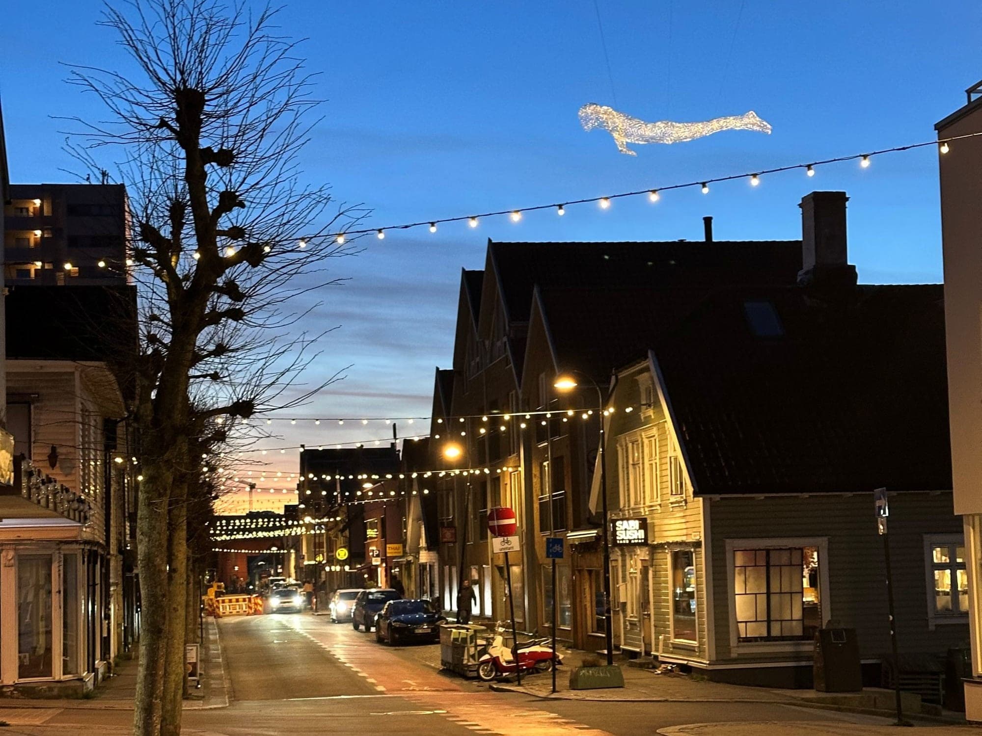 ice sculpture The Travellers looks like it's floating in the air above a street