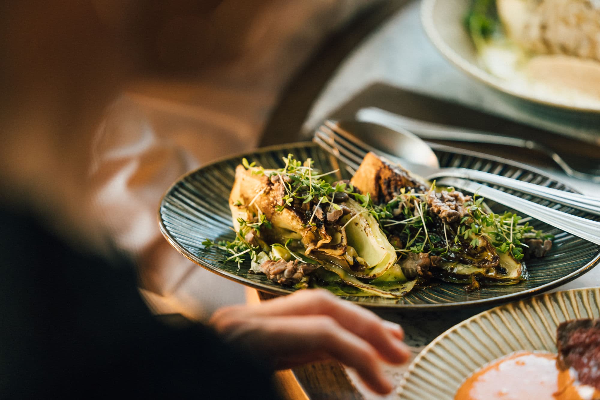 food and people eating at restaurant