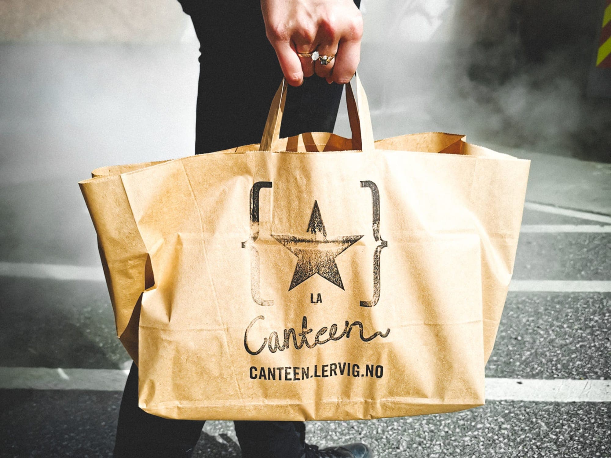 Lervig paper shopping bag held by a man's hand