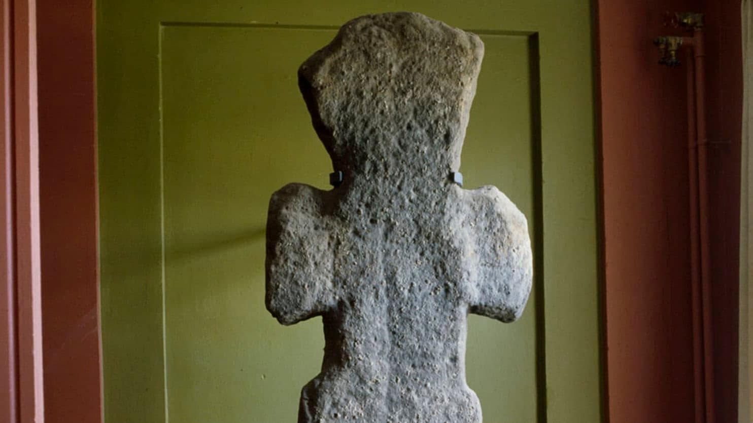 Stone cross showed inside a museum