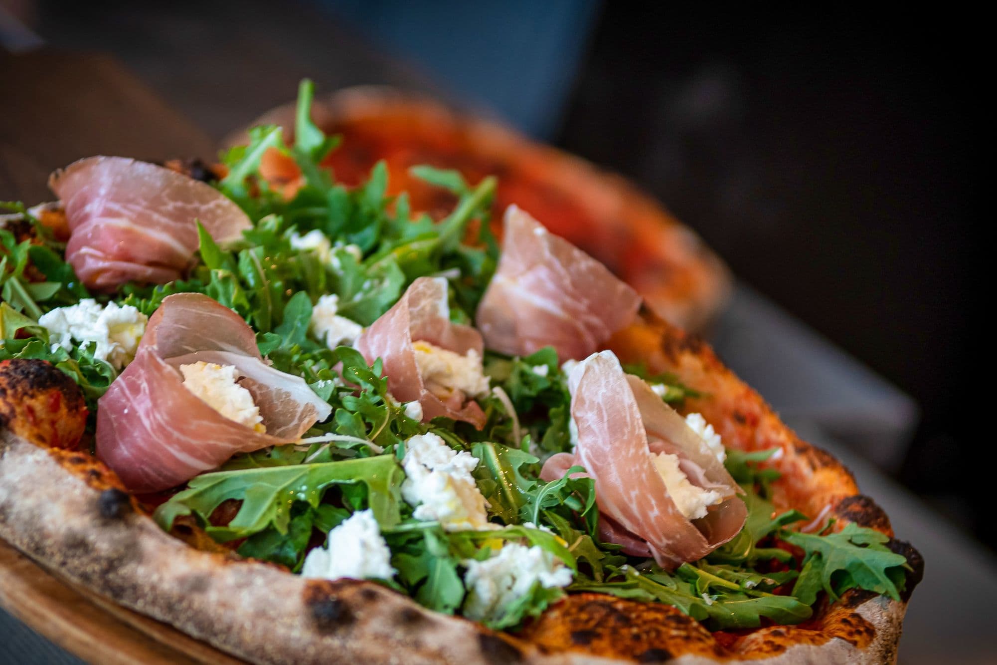 Pizza with smoked ham, cheese and ruccola from restaurant Panzanella