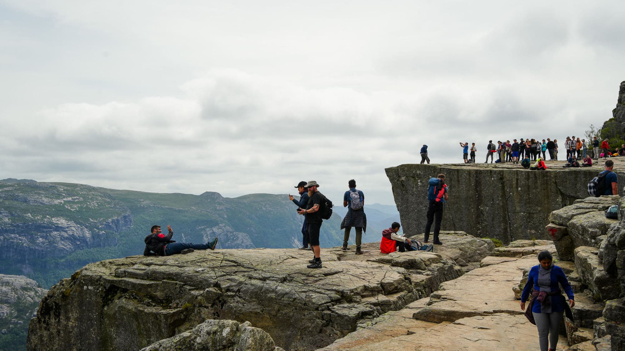 People hiking to Preikestolen in Norway mountain scenery