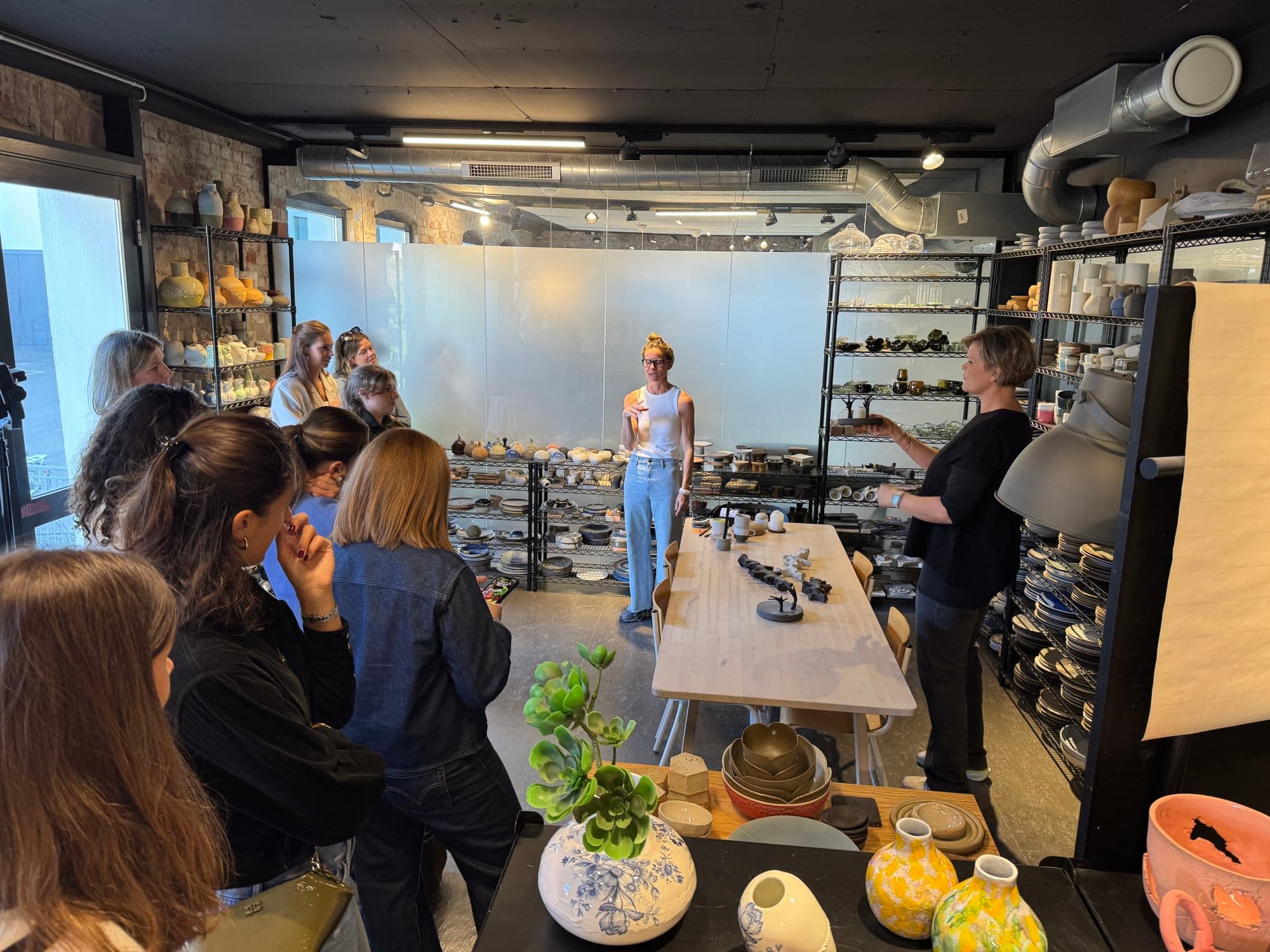 People inside the microshop of Odd Standard a designstudio ceramics on display