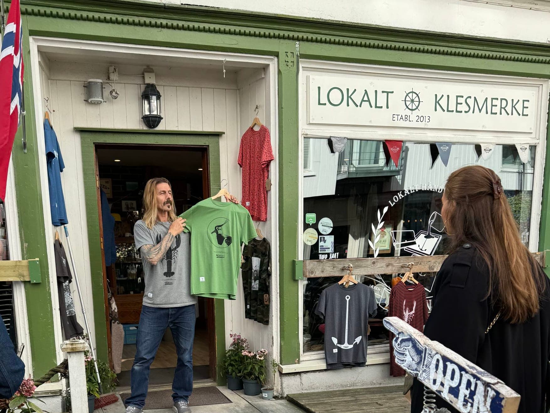 Kant a local handcraft shop in stavanger. The owner in the doorway showing a t-shirt.