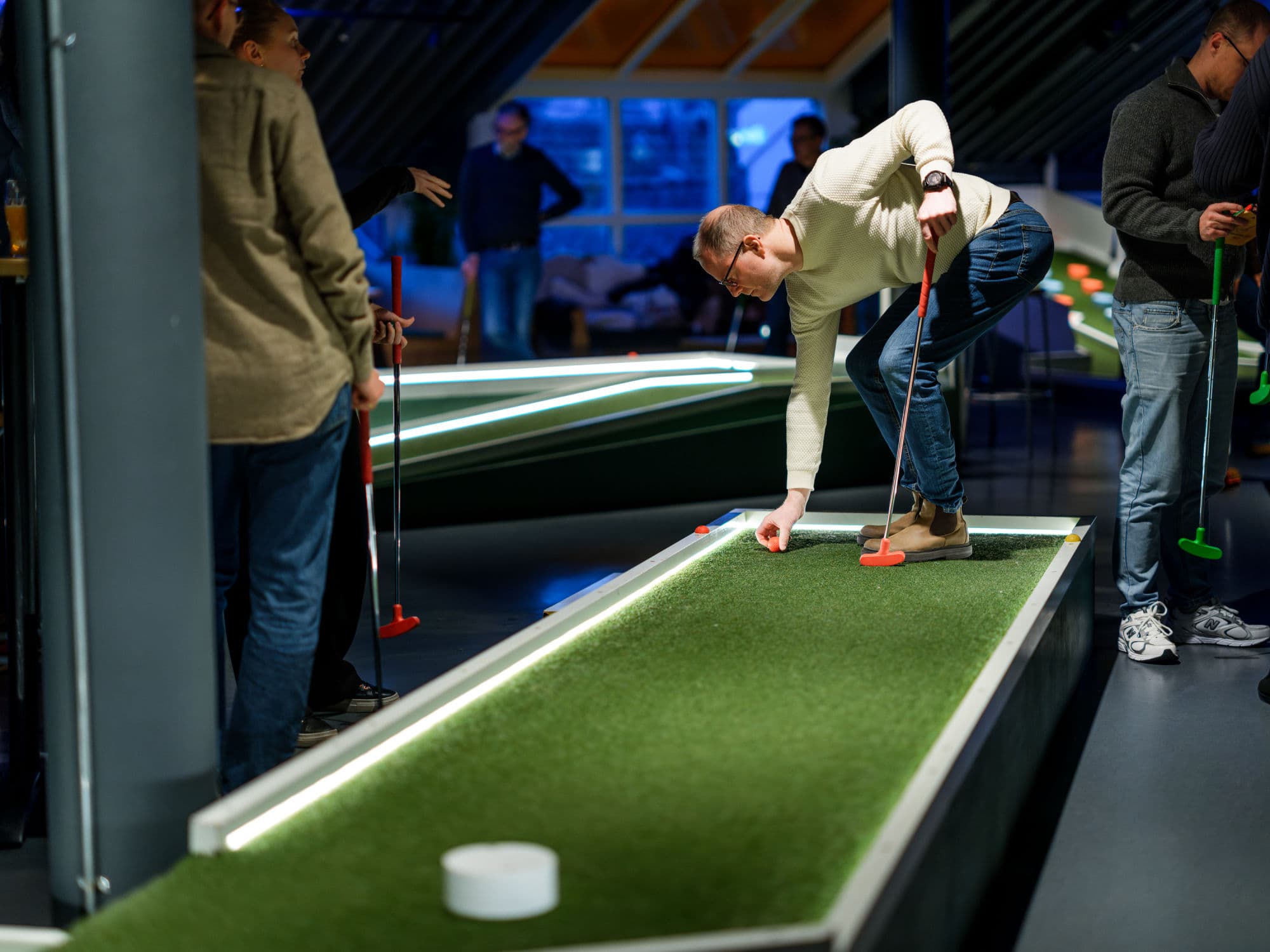 people playing minigolf indoors