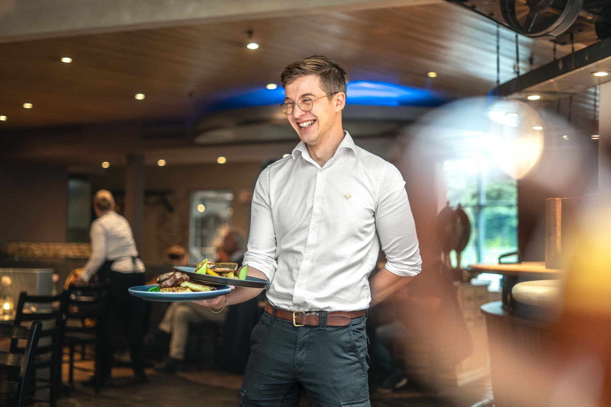 people eating at restaurant, plates of food